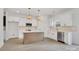 Modern kitchen with white cabinets, gold hardware, and an island at 3050 Swallowtail Ln, Kannapolis, NC 28083