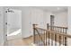 Upstairs hallway with light wood floors and railing at 3050 Swallowtail Ln, Kannapolis, NC 28083