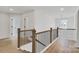 Upstairs hallway with hardwood floors and black metal railing at 3050 Swallowtail Ln, Kannapolis, NC 28083