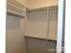 Walk-in closet with shelves and hanging rods at 409 Newstyle Way # 3, Cramerton, NC 28056