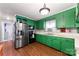 Kitchen with green cabinets, stainless steel appliances, and wood floors at 513 Bell Rd, Kings Mountain, NC 28086