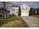 Two-story house with beige siding, a double car garage, and a well-maintained lawn at 6030 Laurent Ave, Fort Mill, SC 29715