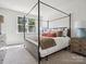 Main bedroom with canopy bed and ample natural light at 7022 Impulse Ct, Charlotte, NC 28205