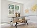 Modern dining room with black table and light wood benches at 7022 Impulse Ct, Charlotte, NC 28205