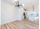 Bright dining room features hardwood floors and modern light fixture at 7022 Impulse Ct, Charlotte, NC 28205