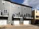 Rear view of townhouses with attached garages and balconies at 7022 Impulse Ct, Charlotte, NC 28205