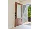 Modern front door with glass panel and black hardware, opening to a sunny walkway at 7022 Impulse Ct, Charlotte, NC 28205