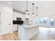 Modern kitchen with white cabinets, quartz countertops, and stainless steel appliances at 7022 Impulse Ct, Charlotte, NC 28205