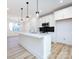 Modern kitchen with white cabinets, quartz countertops, and stainless steel appliances at 7022 Impulse Ct, Charlotte, NC 28205