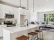 Open concept kitchen features white cabinets, island with seating, and stainless steel appliances at 7022 Impulse Ct, Charlotte, NC 28205