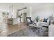 Open living room with modern furniture, kitchen island and breakfast bar at 7022 Impulse Ct, Charlotte, NC 28205