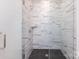 Large walk-in shower with marble tile and glass door at 7022 Impulse Ct, Charlotte, NC 28205