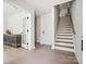 Modern staircase with light hardwood treads and white risers at 7022 Impulse Ct, Charlotte, NC 28205