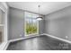 Modern dining room featuring dark gray walls and tile floors at 7708 Spanish Oaks Dr, Waxhaw, NC 28173