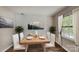 Dining area with modern wood table and white chairs at 849 Nottingham Dr # 62, Gastonia, NC 28054