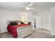 Main bedroom with a red comforter and ceiling fan at 923 Slick Rock Rd, Chester, SC 29706