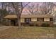 Brick ranch home with a well-maintained lawn and mature trees at 124 Redwood Ln, Gastonia, NC 28052