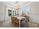 Spacious dining room featuring a stylish chandelier and large windows at 1435 Hubert Graham Way, Tega Cay, SC 29708