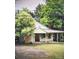 Light green house with covered porch and mature trees at 1506 Eaves Rd, Shelby, NC 28152