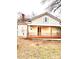 Tan house with a front porch, wooden railings, and a yard at 212 E 11Th St, Salisbury, NC 28144