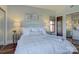 Main bedroom with a queen bed and access to a private balcony at 224 N Poplar St # 19, Charlotte, NC 28202