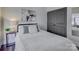 Cozy bedroom with dark-colored closet doors and soft bedding at 224 N Poplar St # 19, Charlotte, NC 28202