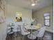 Elegant dining area with a round table and four white chairs at 224 N Poplar St # 19, Charlotte, NC 28202