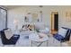 Living area with comfy seating, a coffee table, and large artwork at 224 N Poplar St # 19, Charlotte, NC 28202