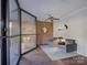 Lobby area with brick wall, seating area and large window at 224 N Poplar St # 19, Charlotte, NC 28202