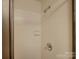 Simple shower with white tile and basic fixtures at 224 N Poplar St # 19, Charlotte, NC 28202