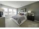 Bright bedroom with large windows, plush bed, and ample space at 3030 Hutton Gardens Ln, Charlotte, NC 28269