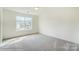 Bright bedroom with large window and carpet flooring at 5404 Verona Rd # 36, Charlotte, NC 28213