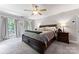 Main bedroom with plush carpet, large bed, and ample natural light at 9552 Man O War Rd, Indian Land, SC 29707