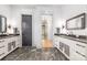 Double vanity bathroom with dark gray floor tile at 10125 Laurier Ln, Huntersville, NC 28078