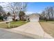 Two-story house with gray siding, a two-car garage, and a driveway at 13005 Seascape Ln, Charlotte, NC 28278