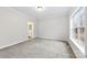 Bright bedroom with grey carpet and large window at 139 Fairhaven Ln, Cleveland, NC 27013