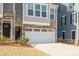 Two-story townhome with stone and siding accents, featuring a two-car garage at 2011 Dornoch Rd, Fort Mill, SC 29708