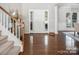 Bright entryway with hardwood floors and staircase at 3735 Watts Bluff Dr, Charlotte, NC 28213