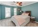 Bedroom with teal walls, plantation shutters, and a ceiling fan at 509 N Graham St # 1G, Charlotte, NC 28202