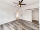 Bedroom with ceiling fan, wood-look floors, and sliding barn door closet at 718 Grover St, Gastonia, NC 28054