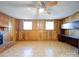 Spacious basement area with wood paneling, flooring, and a fireplace at 7800 Highbanks Ct, Charlotte, NC 28212