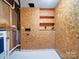 Unfinished basement laundry area with water heater and shelving at 7800 Highbanks Ct, Charlotte, NC 28212