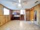 Finished basement room with wood paneling and ceiling fan at 7800 Highbanks Ct, Charlotte, NC 28212