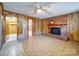 Basement recreation room with brick fireplace and wood paneling at 7800 Highbanks Ct, Charlotte, NC 28212