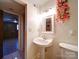 Bright bathroom with pedestal sink and mirror at 7800 Highbanks Ct, Charlotte, NC 28212
