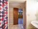 Bathroom with shower, pedestal sink, and access to another room at 7800 Highbanks Ct, Charlotte, NC 28212