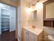 Updated bathroom with vanity, mirror, and shelves at 7800 Highbanks Ct, Charlotte, NC 28212