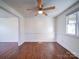 Dining room with hardwood floors, wainscoting, and a ceiling fan at 7800 Highbanks Ct, Charlotte, NC 28212