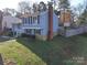 Side view of a gray sided two-story house with yard and fence at 7800 Highbanks Ct, Charlotte, NC 28212