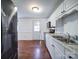 Kitchen boasts stainless steel appliances and white cabinets at 7800 Highbanks Ct, Charlotte, NC 28212